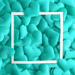 Obraz premium Love concept made of small hearts in turquoise color and frame abstract.