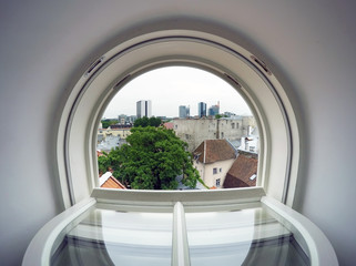 Tallinn. View from the roof window on the roofs of the old town and modern houses in the distance