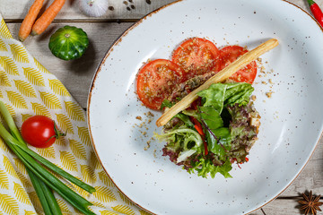 View from above of georgian cuisine on brown wooden table. Traditional georgian cuisine and food - khinkali, kharcho, chahokhbili, phali, lobio and local sauces - tkemali, satsebeli, adzhika. Top view
