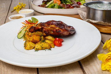 View from above of georgian cuisine on brown wooden table. Traditional georgian cuisine and food - khinkali, kharcho, chahokhbili, phali, lobio and local sauces - tkemali, satsebeli, adzhika. Top view