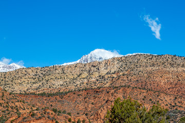 Rugged mountains in Utah, with a snowcapped mountain behind