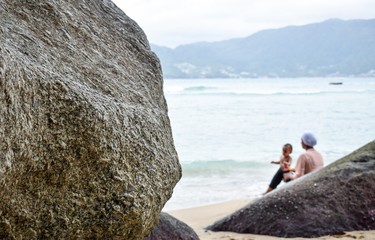 young woman on the beach with her child