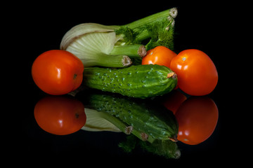 fennel tomatoes and cucumber on a black mirror surface still life