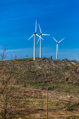 View of a wind turbines on top of mountains