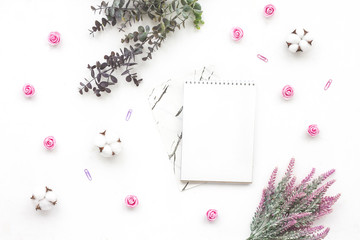 Marble notebook, eucalyptus branch, cotton flowers, rose, lavender on white background, flat lay, top view