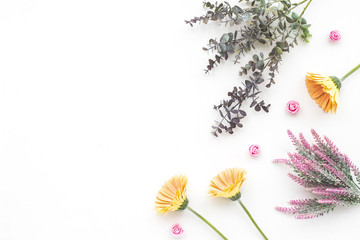 Yellow gerbera flowers, eucalyptus branch, lavender, pink rose on white background, flat lay, top view