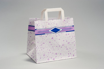 White paper bag with a pattern for shopping, in the studio