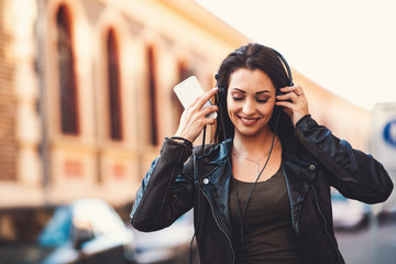 Young woman enjoys music on the street