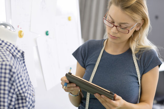 Young businesswoman using digital tablet at her workspace