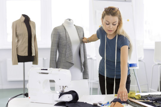 Attractive young businesswoman designer working at her studio