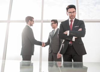 Fototapeta premium businessman on the background of the handshake of business partners