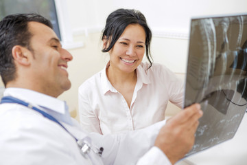 Fototapeta premium Mature doctor talking to a patient