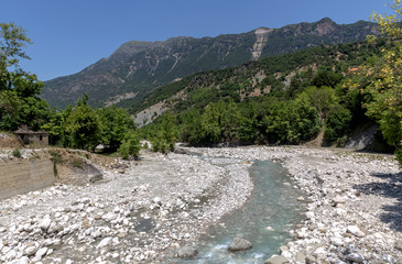 The mountains and the river Kalarrytikos on a sunny summer day.