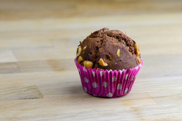 Chocolate and hazelnut muffin on wooden table