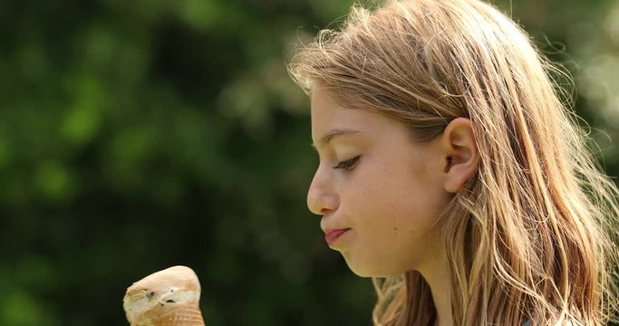 Little girl eating ice-cream outdoors