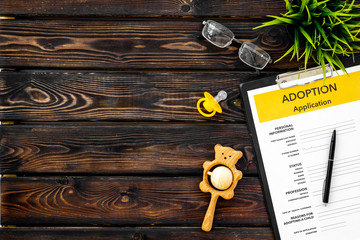 Adoption children concept with form and dummy for baby on wooden background top view mock up