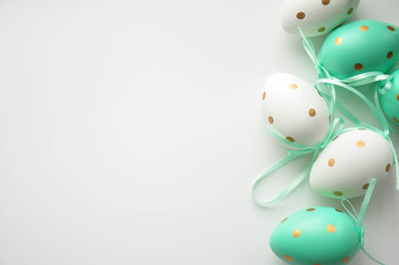 Easter eggs are white blue polka dots. Festive mood. Easter attributes. Easter food. Drawing on the eggs. White tiffany easter background