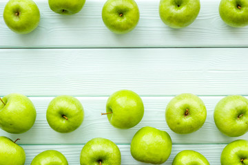 green apples for organic summer food pattern on light wooden background top view mockup