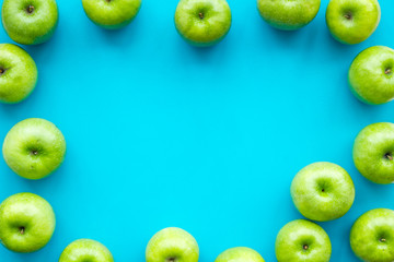 food pattern with green apples on blue background top view space for text