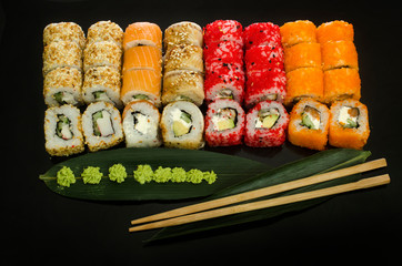 sushi set with different rolls isolated on black