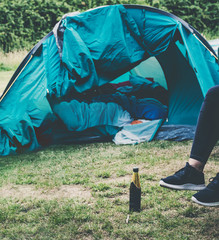 feet of woman sitting relaxed outside a tent