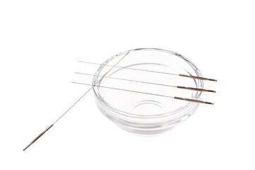 Silver needles for traditional Chinese acupuncture medicine. Isolated white background.