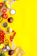 cooking with raw vegetables on yellow background top view mockup