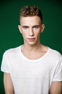 Portrait of confident young man wearing white t-shirt in studio