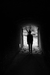  silhouette of person from behind in tunnel