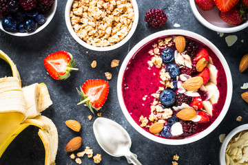Smoothie bowl from fresh berries, nuts and granola.