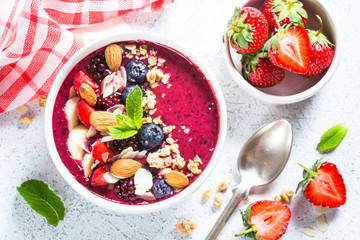 Smoothie bowl from fresh berries, nuts and granola.