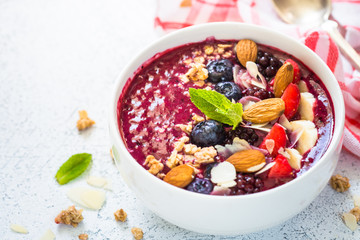 Smoothie bowl from fresh berries, nuts and granola.