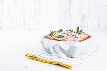 Apple pie in dishes on a white background. Homemade fruit pastries for a delicious breakfast. Free space for text. Copy space.