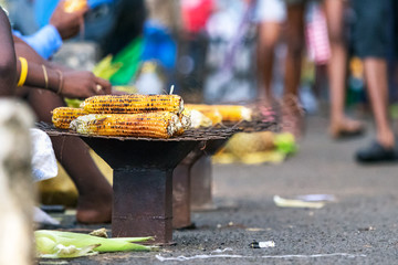 Grilled - roast corn on a coal stove in the street in Nosy Be, Madagascar