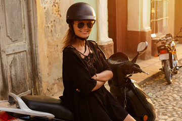 Woman driving scooter by the old city streets © blackday
