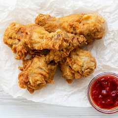 Fried chicken legs with ketchup, top view. From above, overhead.