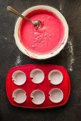 dough pink raw spread in the baking dish - cupcakes