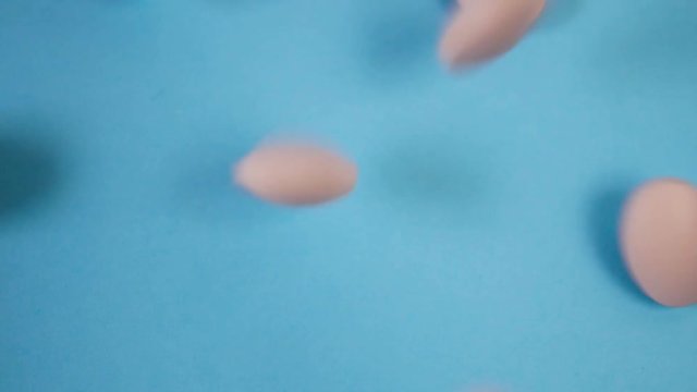 tablets fall on a blue background and roll