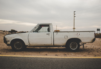 old abandoned vintage pickup car in cloudy desert outdoor scenic landscape environment 