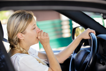 sleepy woman driving her car