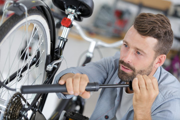 man pumping up bike