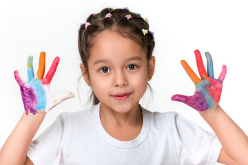 cute little child girl with hands painted in colorful paint isolated on white background.