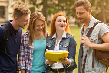 College friends chatting outdoors at the campus