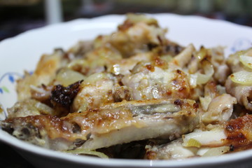 chicken fried with onions on a plate close-up