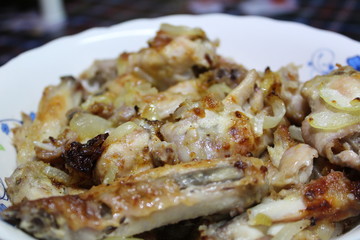 chicken fried with onions on a plate close-up