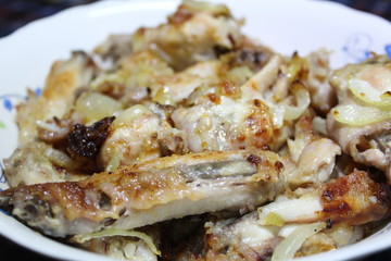 chicken fried with onions on a plate close-up