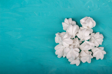 delicious meringue on turquoise background
