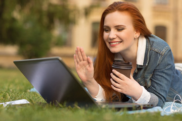 Young female student using gadgets on campus