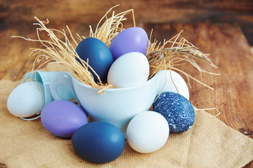 Easter colored eggs in egg nest cup, soft focus image. Happy Easter Card