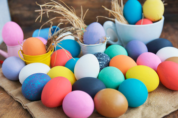 Fototapeta na wymiar Easter colored eggs in egg nest cup, soft focus image. Happy Easter Card